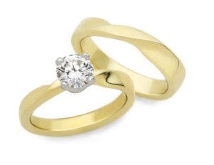 The Möbius Twist wedding set in yellow gold and a round natural mined diamond.