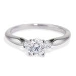 3 diamond ring Round center diamond and mini side round diamonds Platinum 4 prong with airline