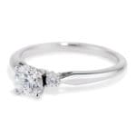 3 diamond ring Round center diamond and mini side round diamonds Platinum 4 prong with airline