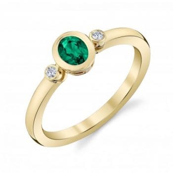 Emerald and Diamond bezel set ring in yellow gold