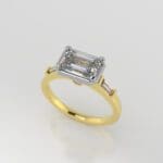 Luna - Emerald cut diamond set sideways with two accent baguette shaped diamonds in two tone.