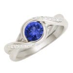 Embrace - Platinum with blue sapphire and diamonds in the band.