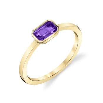 An amethyst bezel set into a simple ring with a slender band in 14K yellow gold. A minimalistic ring with a pop of color. 21020-RAM