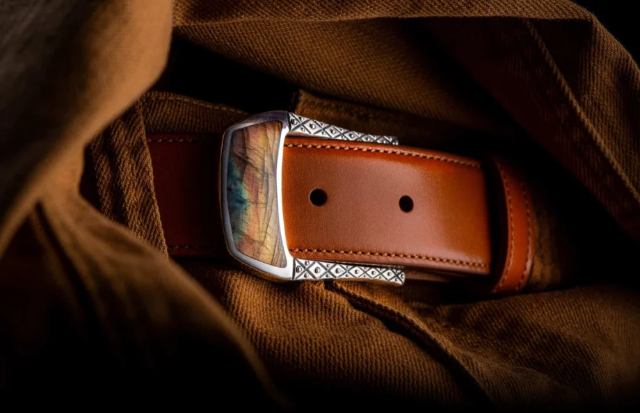 William Henry Belt Buckle 3 - Labradorite on a brown leather belt buckled into beige pants