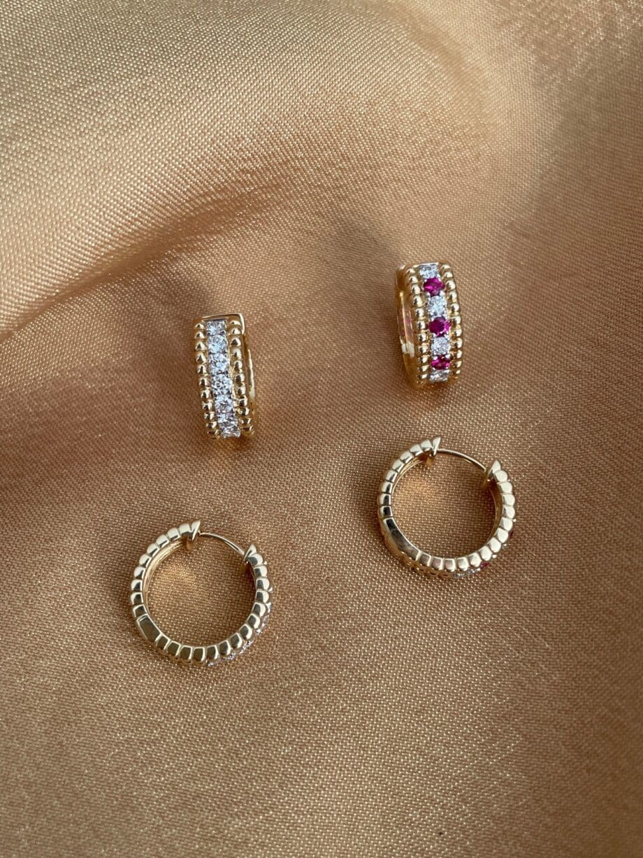 Beaded diamond Huggie hoops shown with a ruby and diamond pair.