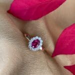Oval ruby and diamond halo ring