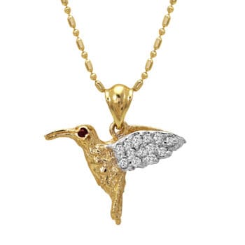 14K yellow gold hummingbird pendant with pavé diamond wing, ruby eye, and white gold detailing. Chain not included.