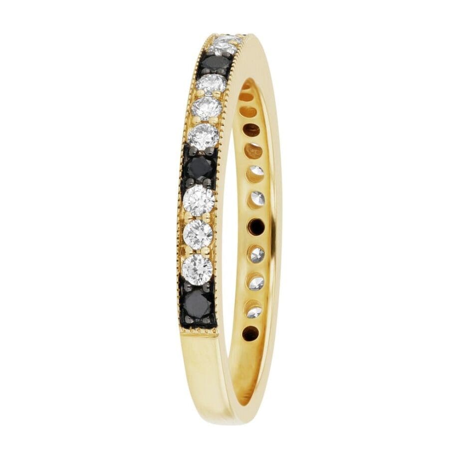 14K yellow gold diamond band with alternating white and black diamonds in a shared prong setting, detailed with milgrain edging. Side View 2