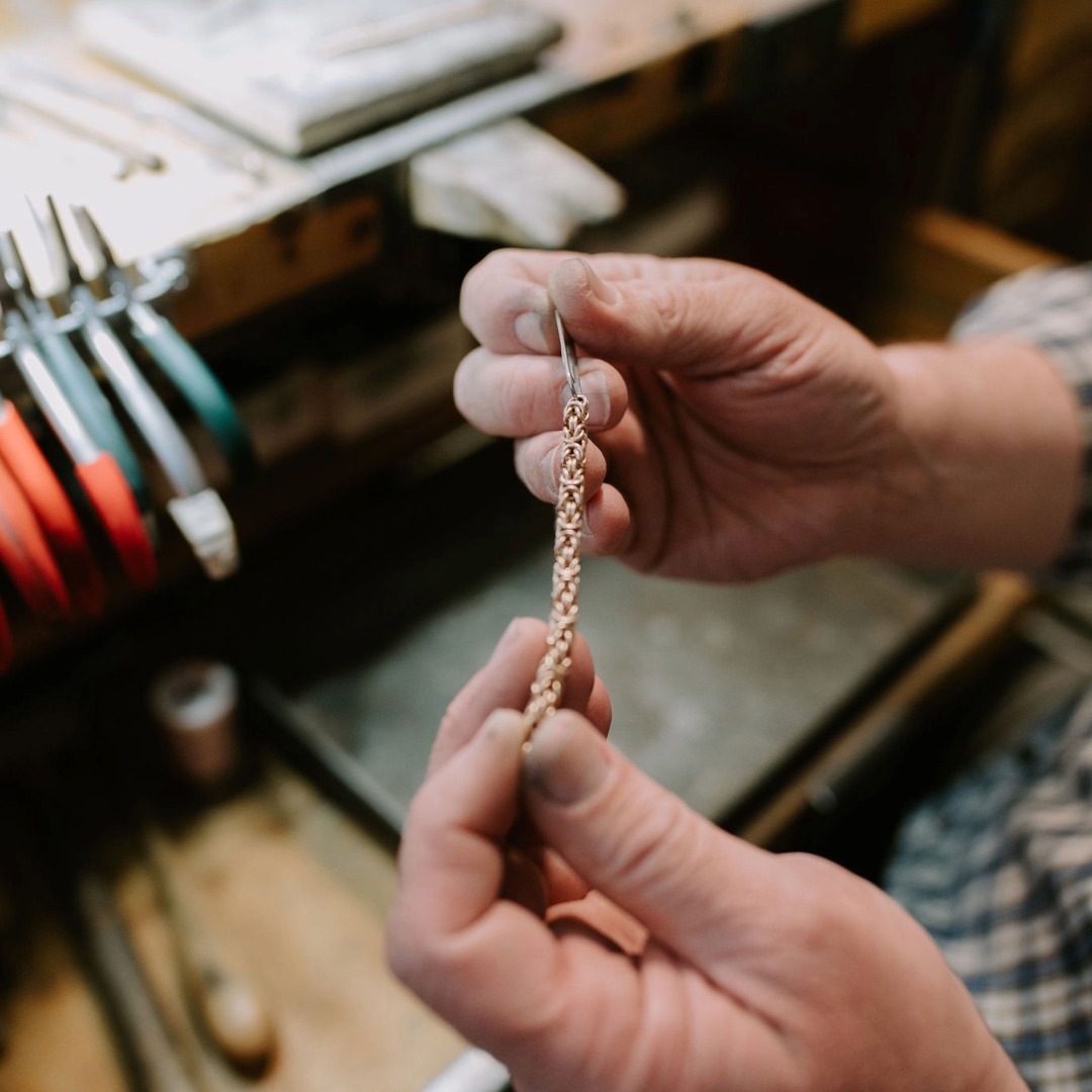 Jeweler hands showing a chain repair and clasp replacement