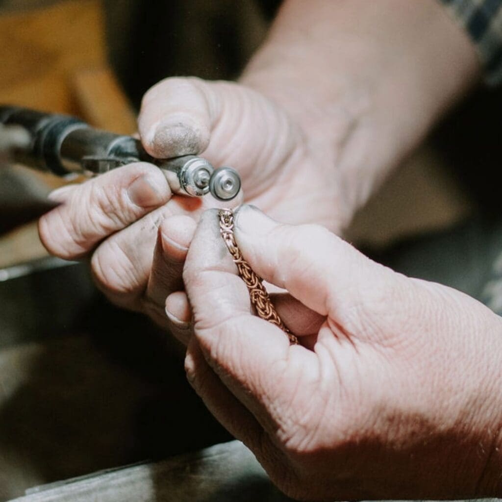 Jeweler making a chain repair and clasp replacement