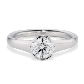 Partial bezel set solitaire engagement ring with 1.01ct round diamond in polished platinum band