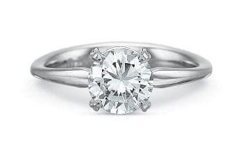 Diamond Silk Engagement Ring in Platinum featuring a 0.74 carat round center diamond with side melee diamonds
