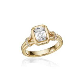 Emerald cut diamond engagement ring in 14K yellow gold with bezel setting and split shank accented by small diamonds