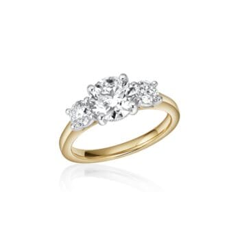 Two-tone engagement ring in 14K yellow gold and platinum featuring three round brilliant diamonds