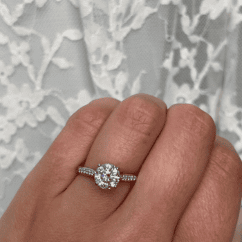 Round Diamond Jubilee Ring in platinum featuring a 1.20 carat round diamond with pavé diamonds in a four-prong cathedral setting