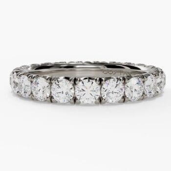 French pavé half-way diamond band in platinum featuring a row of diamonds on half the band
