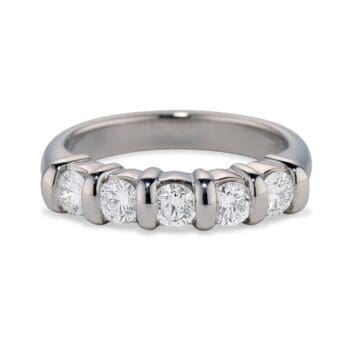 Platinum band ring featuring five round diamonds set in a protective bar setting, size 6.5