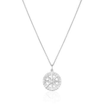 Compass Rose pendant in 14K white gold featuring a round diamond with bead setting