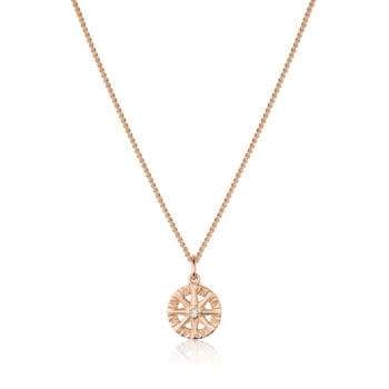 Compass Rose pendant in 14K rose gold featuring a single round diamond center