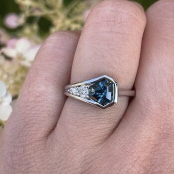 Teal sapphire ring with trilliant diamond accents set in 14K white gold, finger size 6.5