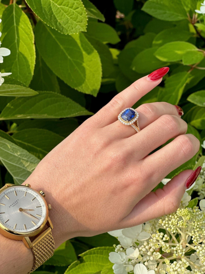 Four carat blue sapphire and diamond halo ring set in 18K yellow gold