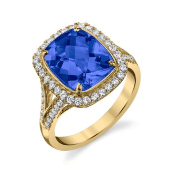 Four carat blue sapphire and diamond halo ring set in 18K yellow gold