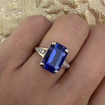 Tanzanite Ring New Horizon with deep purple center gemstone and emerald cut side gemstones set in platinum, size 6.25