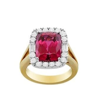 Elongated cushion-cut rubellite halo ring with 16 round and 2 baguette diamonds set in 18K two-tone gold