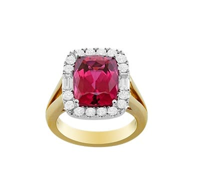 Elongated cushion-cut rubellite halo ring with 16 round and 2 baguette diamonds set in 18K two-tone gold
