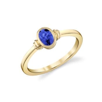 14K yellow gold ring featuring an oval blue sapphire gemstone