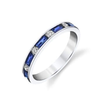 Anniversary ring featuring a blue sapphire center gemstone flanked by emerald cut diamonds in 14K white gold, size 7.25