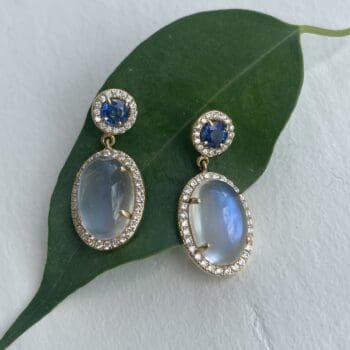 Moonstone and blue sapphire drop halo earrings in 14K yellow gold with post dangle backs