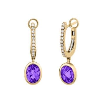 Pair of 14K yellow gold huggie earrings featuring oval purple amethyst gemstones and diamond accents