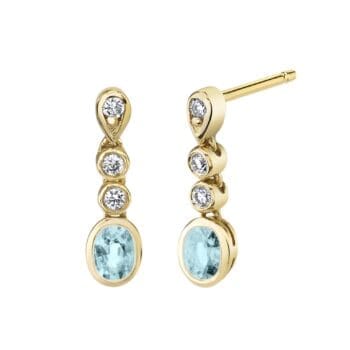 Light blue oval aquamarine drop earrings set in 14K yellow gold with diamond accents