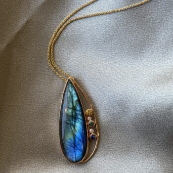 Free form labradorite pendant set in 14K yellow gold