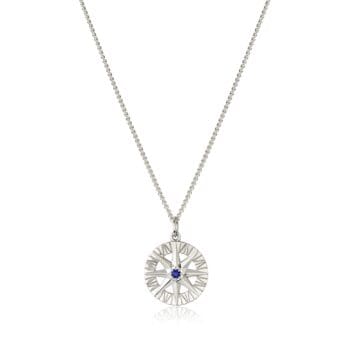 Compass Rose pendant featuring a blue sapphire center and round diamonds in 14K white gold