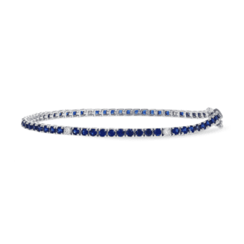 14K white gold tennis bracelet featuring a central sapphire gemstone and round diamonds along the band