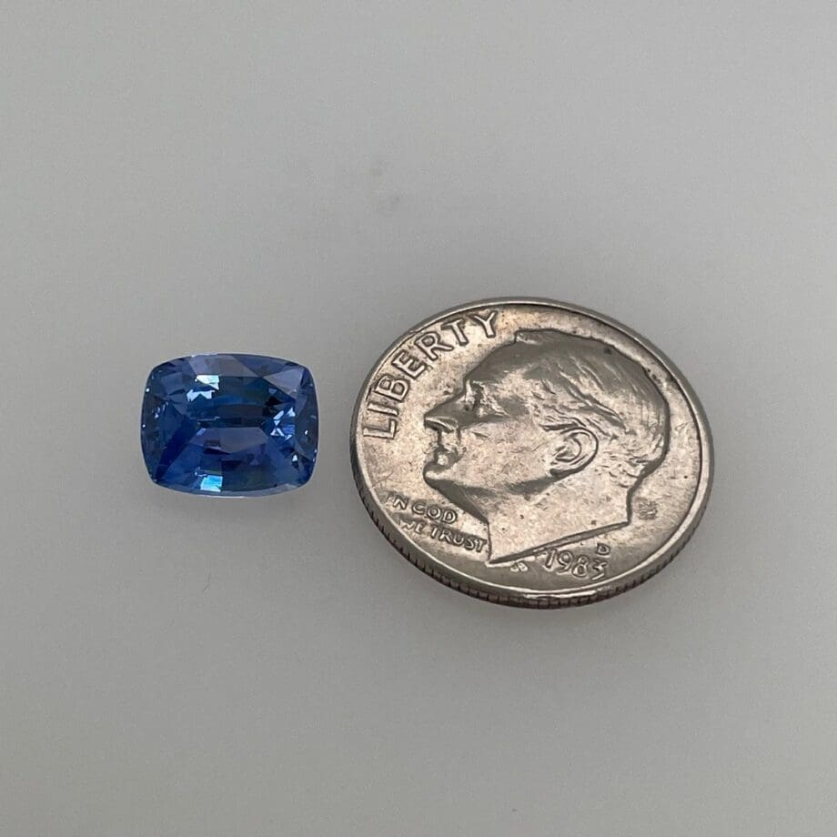 2.38 carat cushion cut vivid blue sapphire gemstone measuring 6.8 by 8.4 millimeters