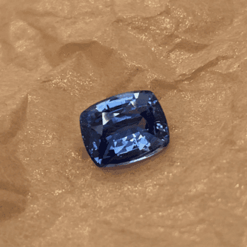 2.38 carat cushion cut vivid blue sapphire gemstone measuring 6.8 by 8.4 millimeters