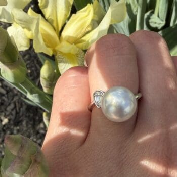 14K white gold ring featuring a 10.95mm button-shaped South Sea pearl and a pear-shaped diamond cluster