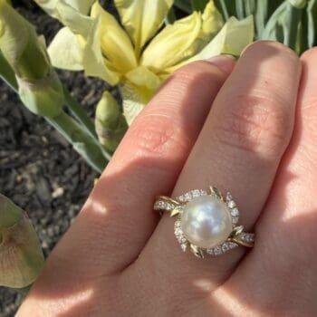 14K yellow gold ring featuring a 5.44mm freshwater pearl center and seven diamond accents