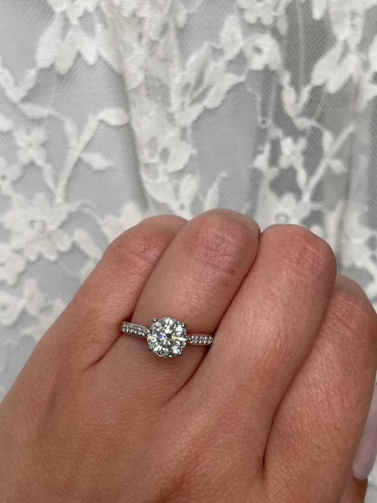 Round Diamond Jubilee Ring in Platinum featuring a 1.20 carat round diamond in a 4-prong setting with pavé diamonds on the band