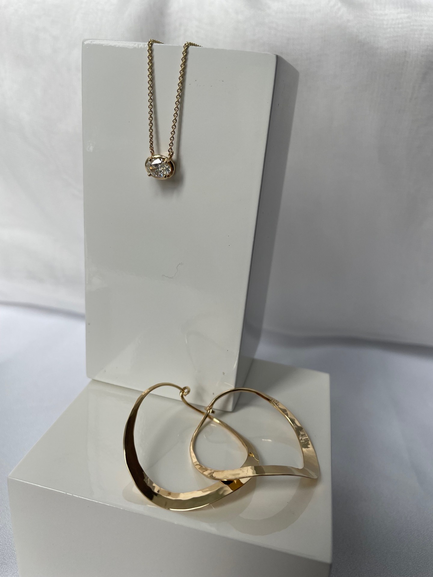 Oval diamond pendant necklace in 14K yellow gold featuring a prong-set 0.58 carat oval diamond