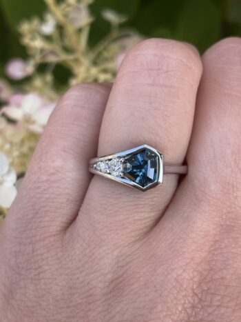 Teal sapphire ring in 14K white gold with trilliant diamond accents