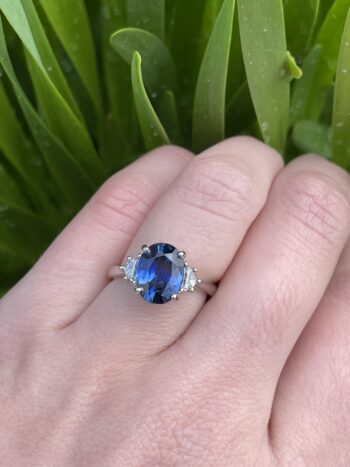 Oval Blue Sapphire and Diamond Trellis Ring in Platinum featuring a 3.14ct oval sapphire with two Cadillac-cut diamonds