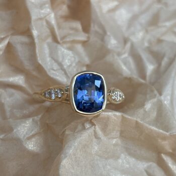 Blue Sapphire Concerto Ring in 18K Yellow Gold with cushion-cut sapphire and diamond accents
