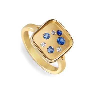 Blue Sapphire and Diamond Galaxy Ring with round blue sapphires and two diamonds set in 14K yellow gold on a domed band
