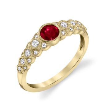 Ruby ring with a round red ruby center, surrounded by diamond accents set in milgrain bezels on a 14K yellow gold band