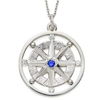Compass Rose pendant in 14K white gold featuring a round blue sapphire center and four round brilliant diamonds at compass points