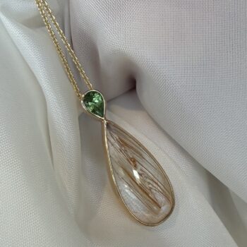 Pear-shaped rutilated quartz pendant accented with pear-shaped diamonds in 14K yellow gold